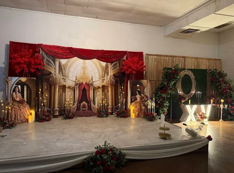 Printed palace backdrop with life-size cutouts of the quinceanera on both sides