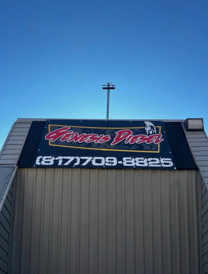 Large outdoor vinyl banner for Genesis Diesel mounted high on a shop facade