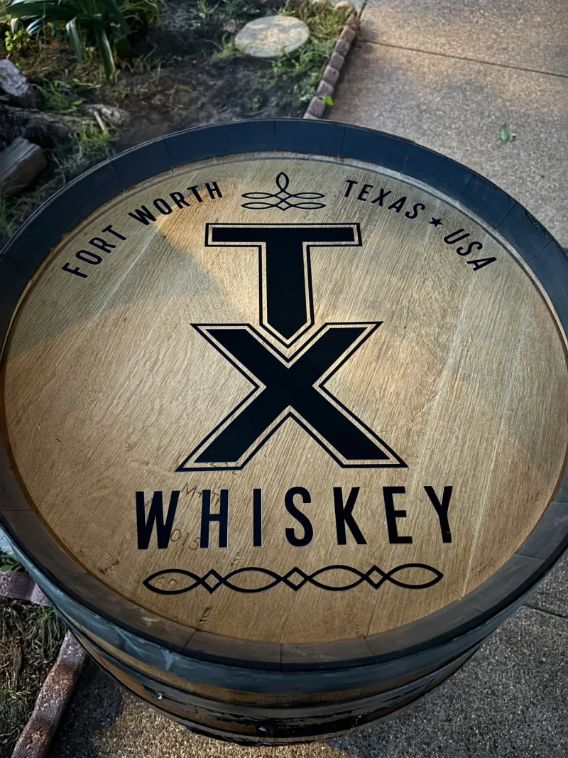 Oak whiskey barrel head with cut vinyl TX Whiskey Fort Worth branding