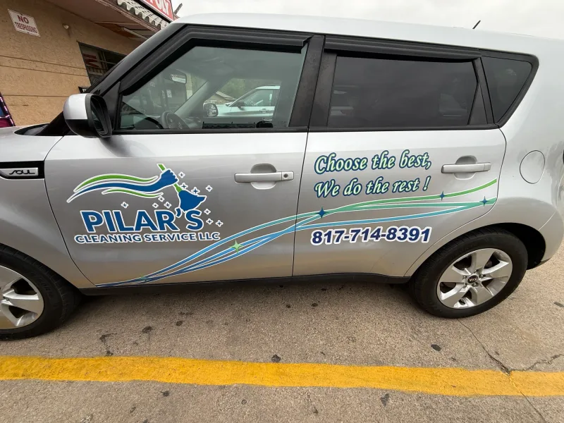 Silver Kia Soul with cut vinyl decals for a cleaning company, logo and phone number