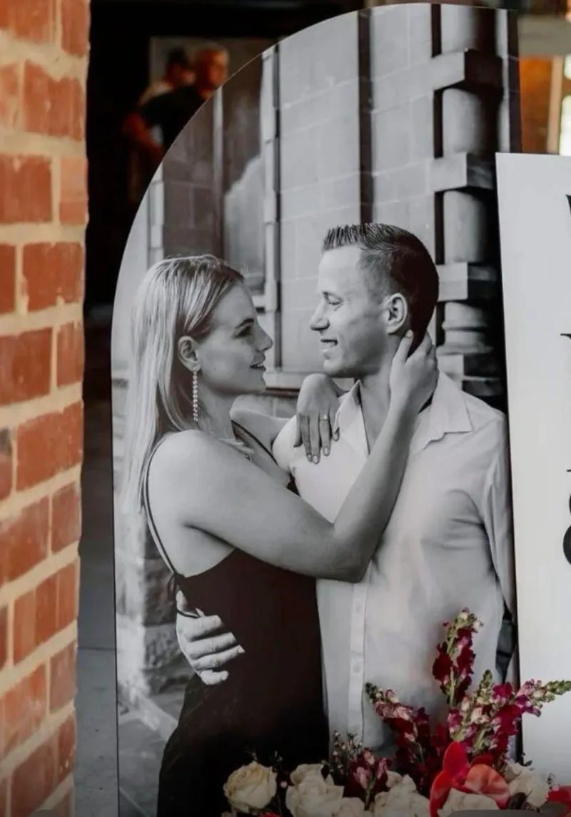 Arched printed foam board of a couple used as wedding entrance signage