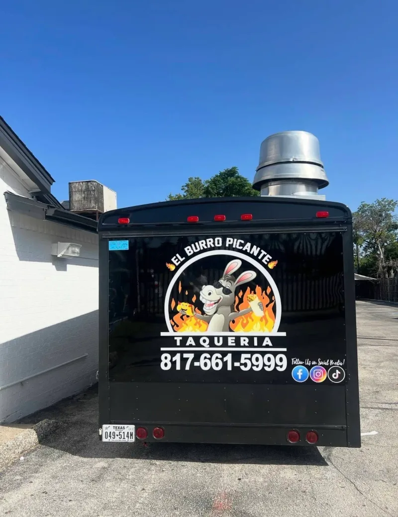Black food truck with printed El Burro Picante Taqueria logo on the rear door